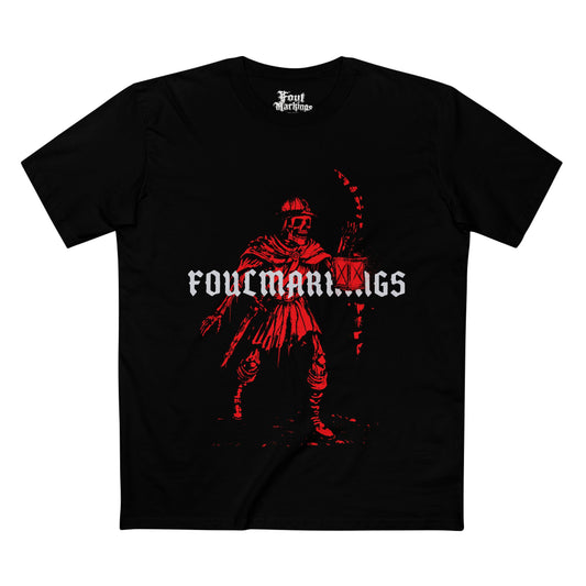 Black tee with a lantern-carrying figure creeping through a dungeon