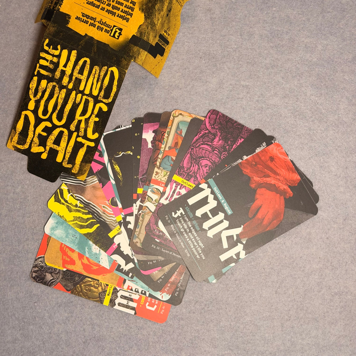 The Hand You're Dealt sleeve with a fan of background cards, Thief on top