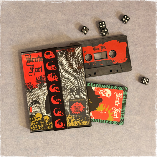 Brute Fort cassette case with skull band, tape, card box and dice on grey felt