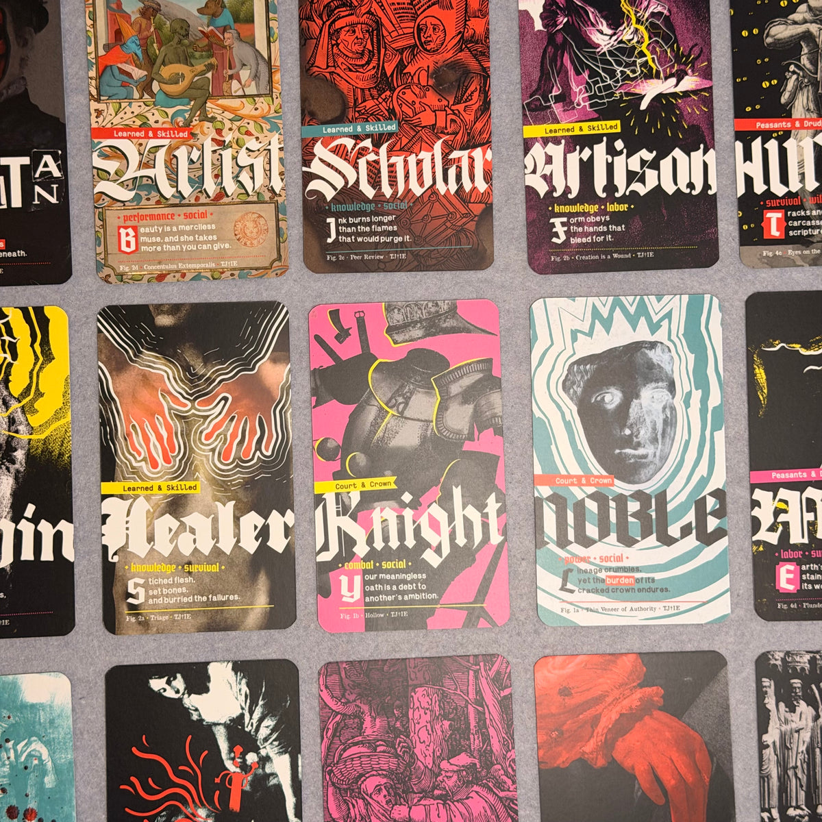 Close-up of background cards including Artist, Scholar, Artisan, Healer, Knight and Noble