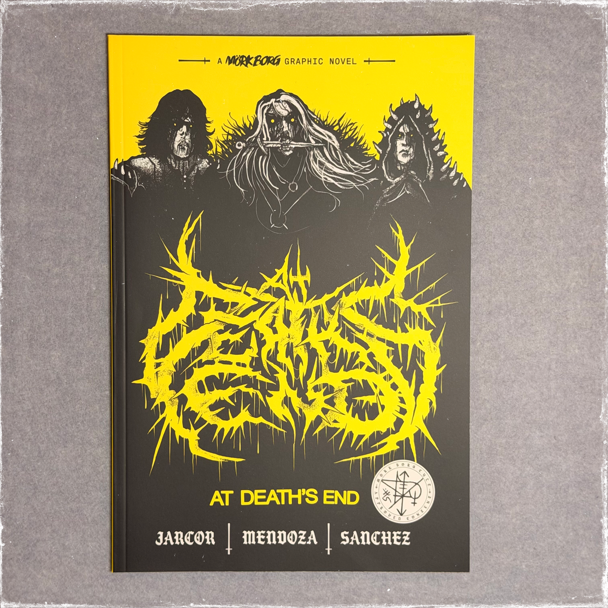 Graphic novel cover in black and yellow, three figures above blackletter title lettering