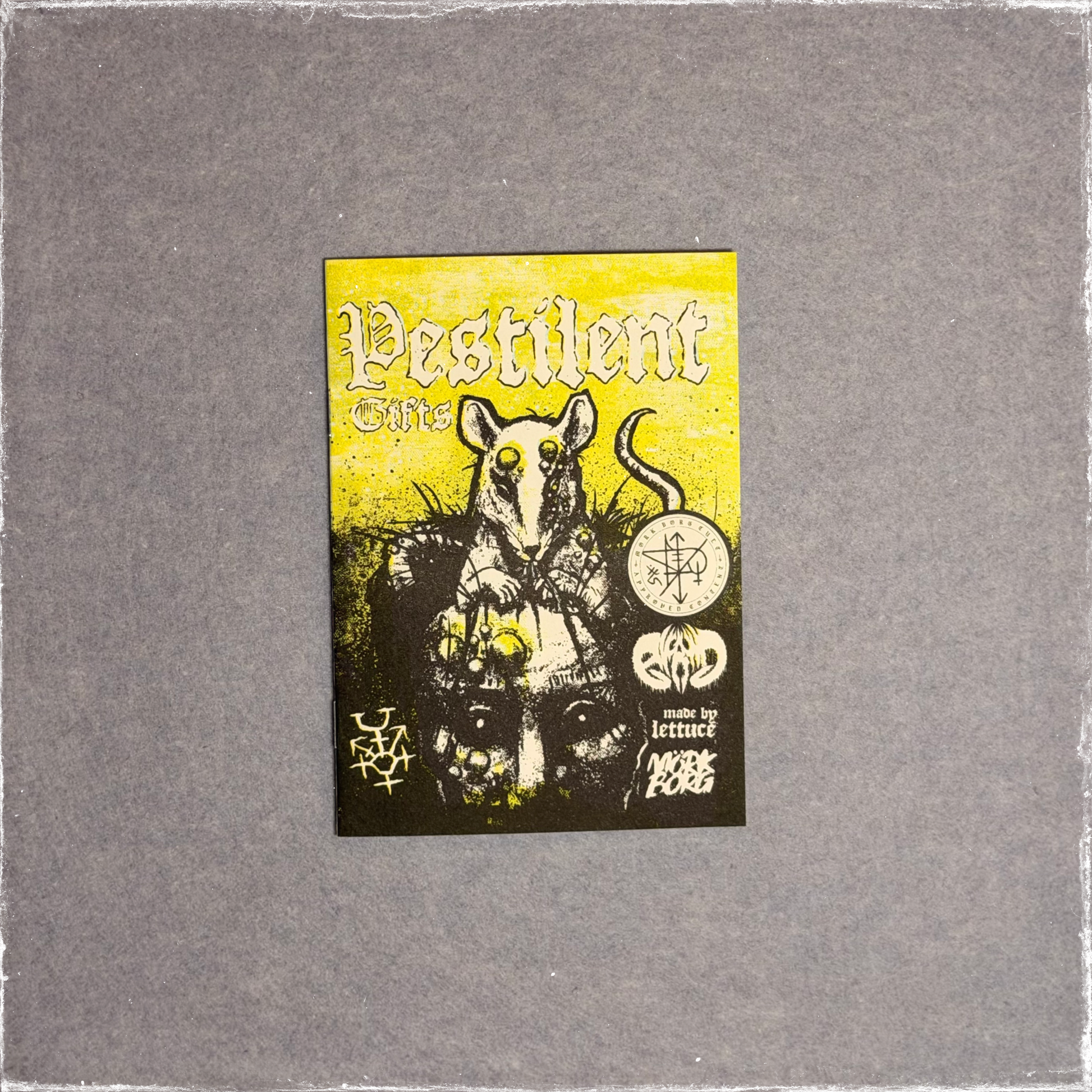 Small zine cover in yellow and black, a rat standing over a pile of skulls