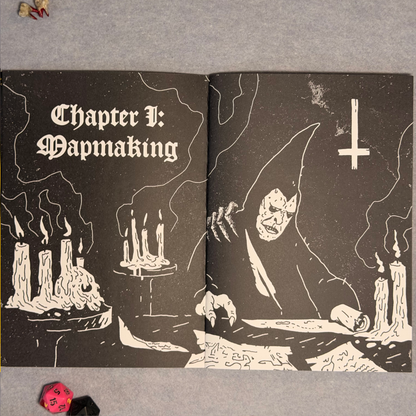 Interior spread, Chapter I Mapmaking, with candles and a reaching skeletal hand