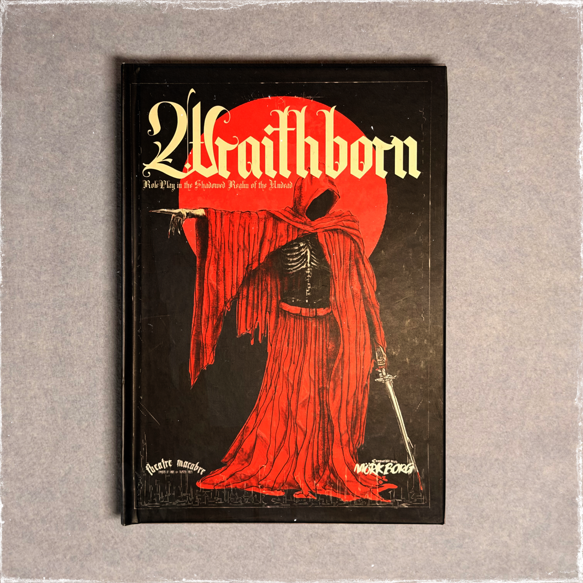 Black hardback cover with a red-robed skeletal figure against a red moon, front view