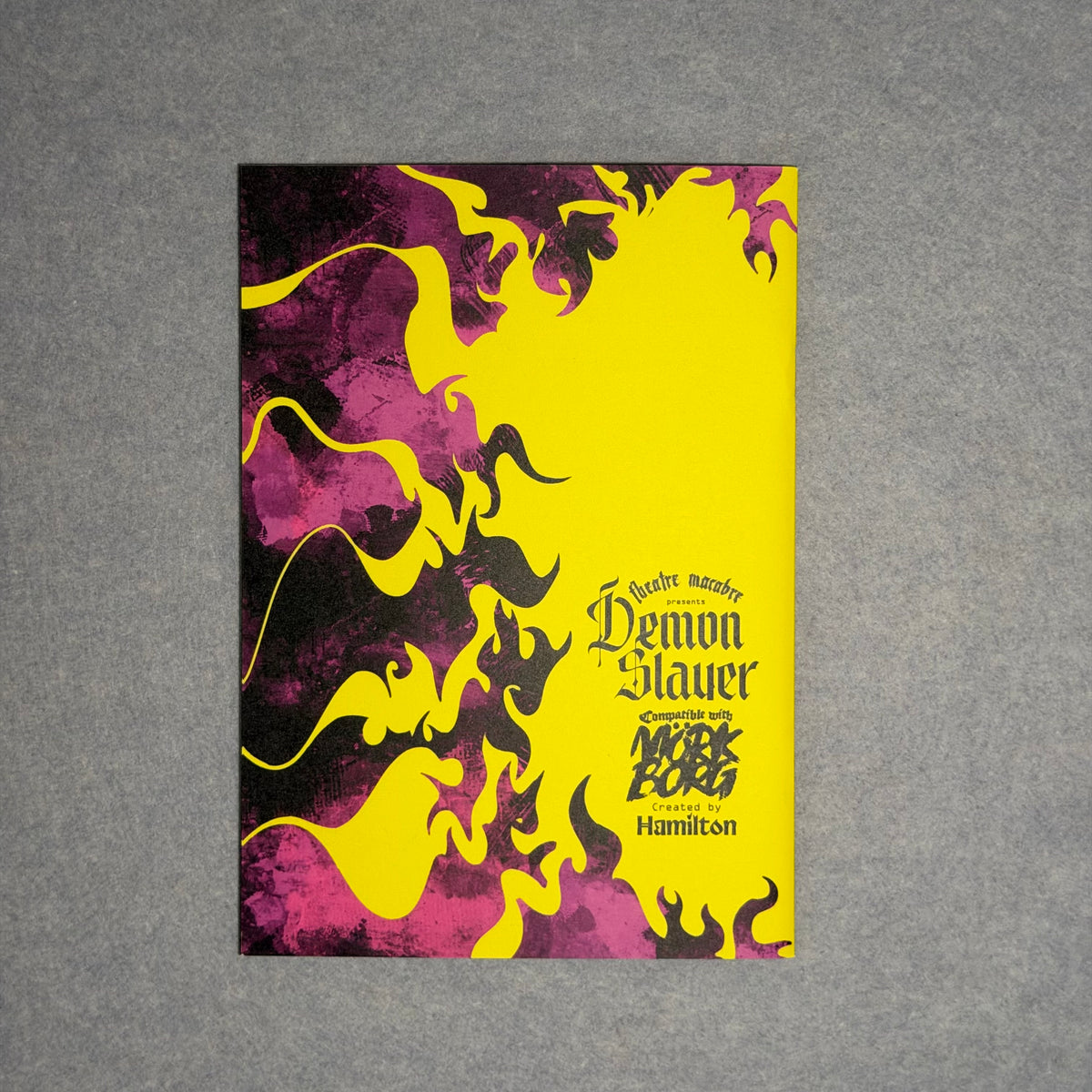 Back cover in yellow and pink with flame shapes and the Theatre Macabre credit