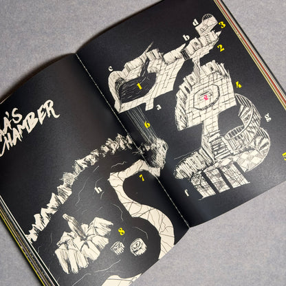 Interior spread, a keyed chamber map in white ink on black with yellow numbers